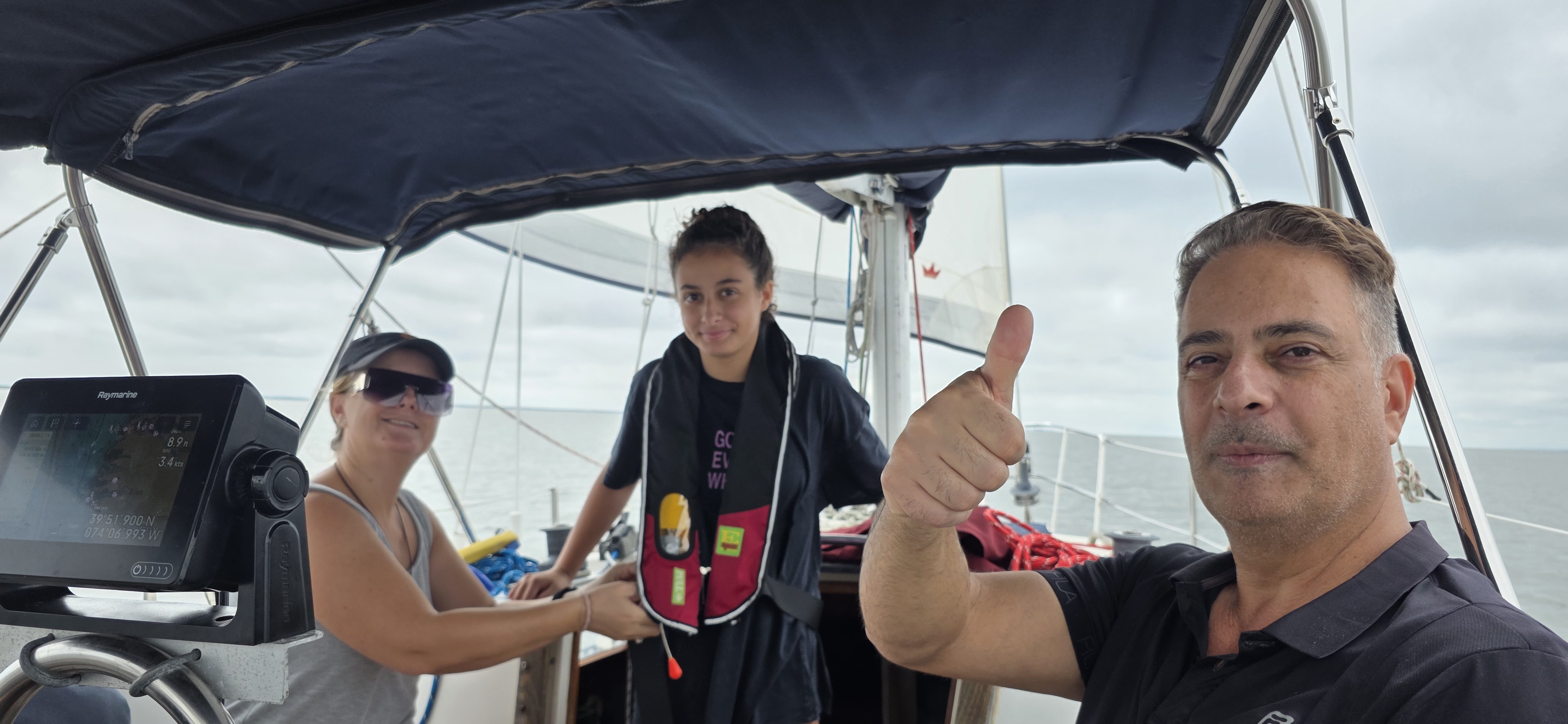 Happy guests thumbs up on Barnegat Bay charter with Raymarine GPS 39.9526 -74.1979