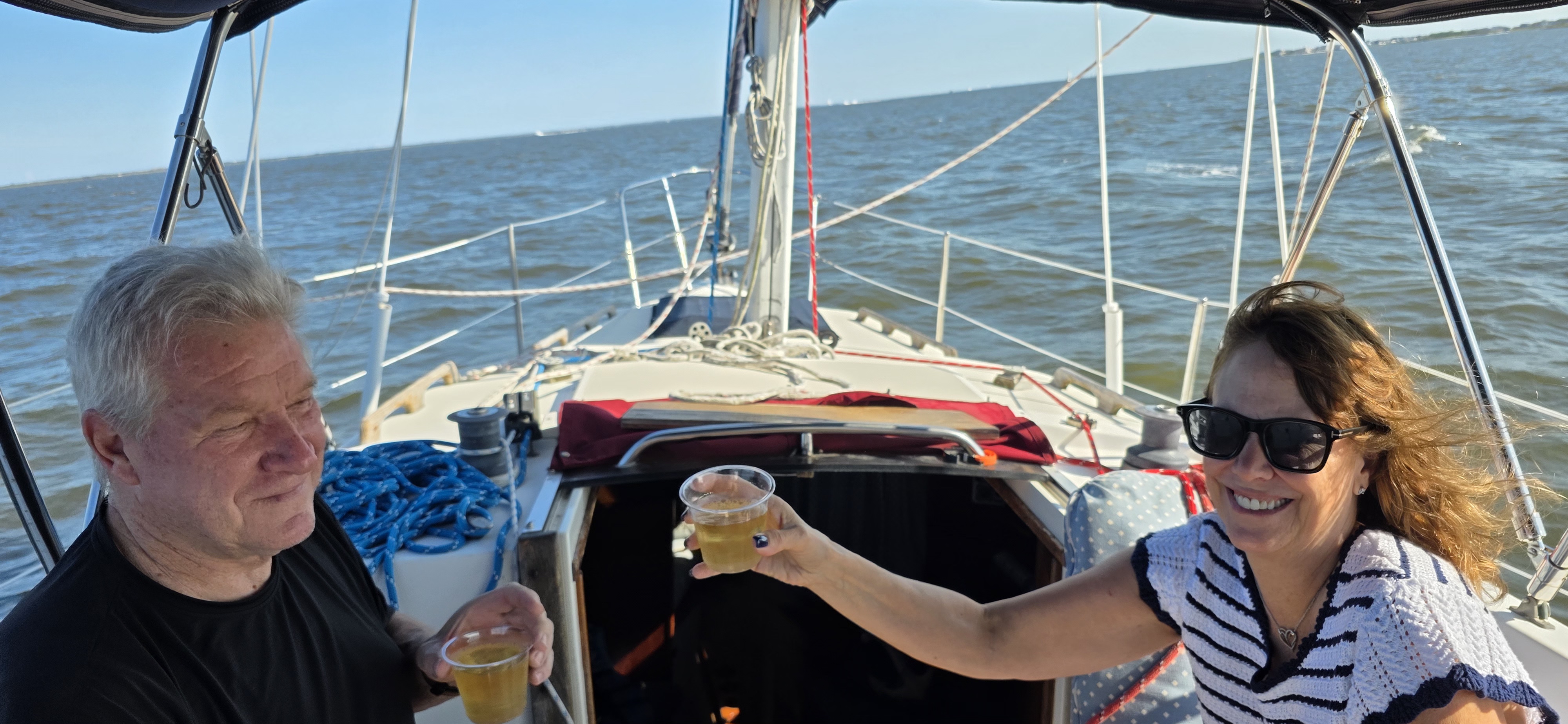 Couple toasting sunset sail Jersey Shore private boat charter unforgettablecharter.com